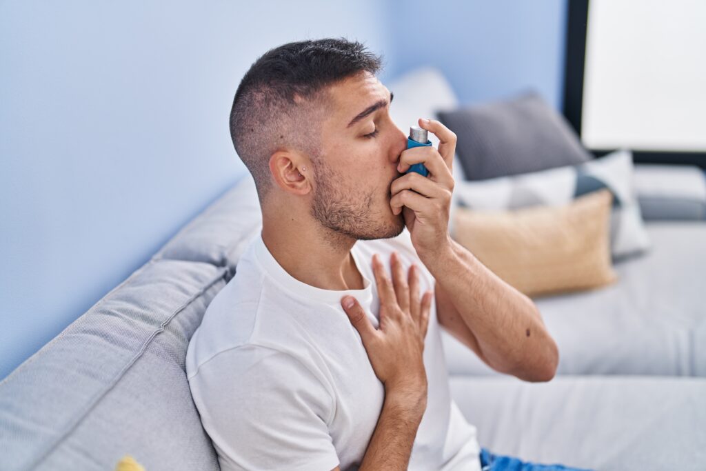 Man using inhaler for asthma at Rashtrotthana Hospital, Bangalore
